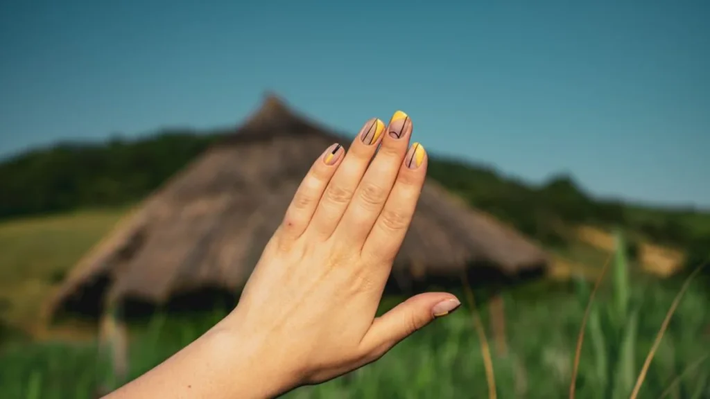 Close up of hands with chestnut brown and tortoiseshell fall nail trends.