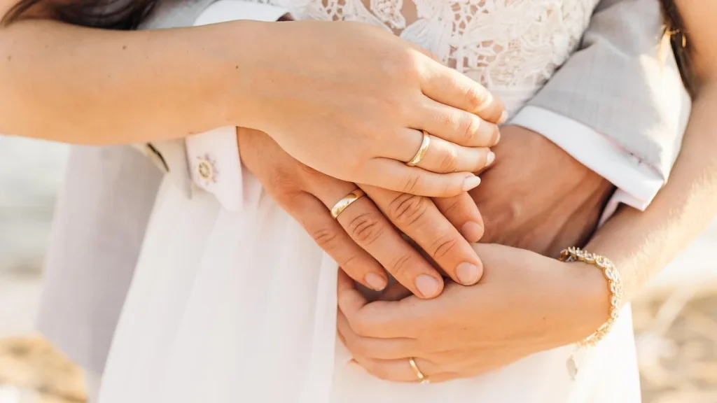 Wedding rings and a notebook resting on a table representing marriage and relationship work.