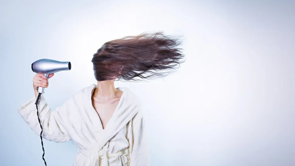 K18 molecular repair hair mask and leave-in spray sitting on a reflective surface.