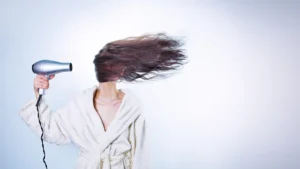 K18 molecular repair hair mask and leave-in spray sitting on a reflective surface.