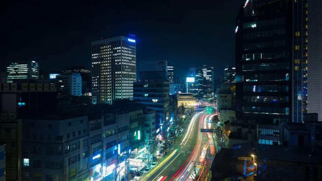 A peaceful evening view of a narrow street with glowing signs in Seoul, South Korea.
