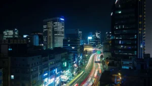 A peaceful evening view of a narrow street with glowing signs in Seoul, South Korea.