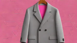A grey tailored wool coat from Mango hanging on a wooden hanger against a neutral background.