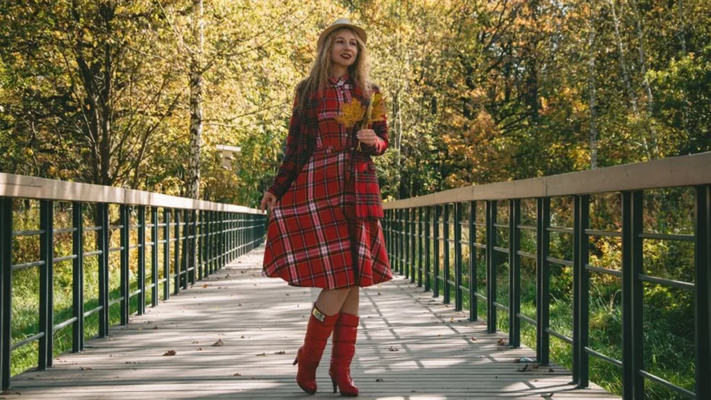 A woman wearing a flattering smocked bodice empire waist dress for fall fashion.