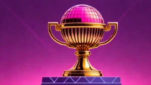 A golden raspberry trophy sitting on a reflective chrome surface against a dark background.