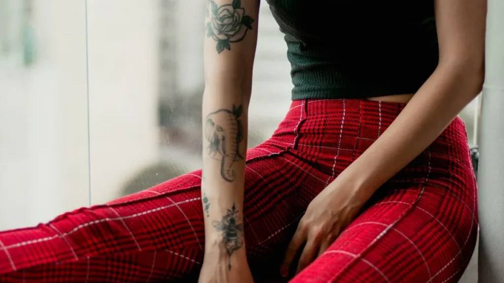 A pair of patterned checked trousers resting on a wooden surface for winter fashion inspiration.
