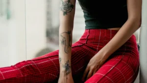 A pair of patterned checked trousers resting on a wooden surface for winter fashion inspiration.